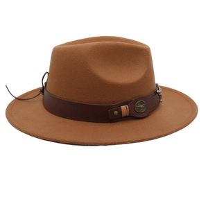 Detail of vintage brown fedora with leather band and metallic bull head buckle ornament