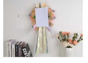 Easter bunny wreath door hanging with mesh ribbons and wooden ears on white wall
