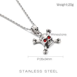 Macro shot of stainless steel skull pendant with red rhinestone eyes and crossbones detail