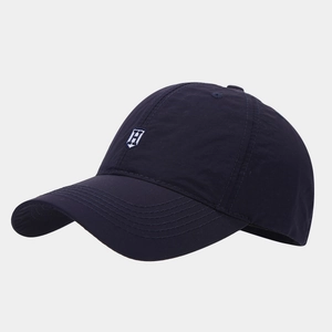 Detailed close-up of dark blue quick-dry baseball cap with white embroidered H logo
