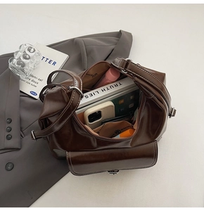 Top view of large capacity dark brown oil wax leather shoulder bag with interior items