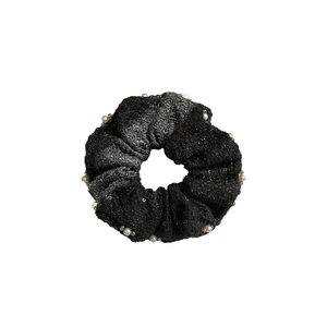 Elegant black tweed scrunchie featuring white pearls and shimmering sequins on white background