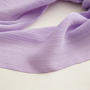 Close-up of lavender chiffon hair scrunchie with detailed dot jacquard texture