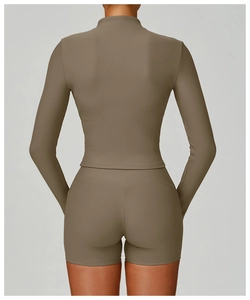 Close-up back view of ribbed yoga set featuring a stand collar jacket and slim shorts