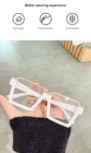 Detail of lightweight white square frame glasses with a golden metal bridge and flexible hinges