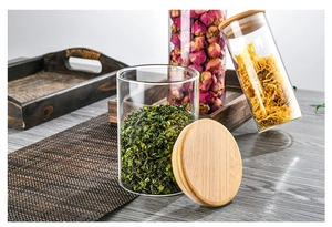 Three airtight glass storage jars with bamboo lids for kitchen food and loose tea