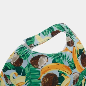 Detailed close-up of the adjustable Velcro strap and tropical banana print on a baseball cap