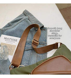 Detail of adjustable brown nylon strap and olive green canvas bag in a lifestyle scene