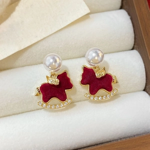 Detail of red flocked rocking horse earrings with pearls and diamonds in a jewelry box