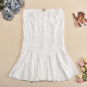 Flat lay of white rib-knit tube mini dress with floral accent and aesthetic background