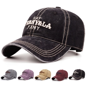 Detail of vintage washed baseball caps with embroidered lettering and distressed edges