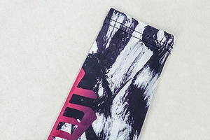 Detail of knit cuff with black-white stroke and fuchsia gradient printed pattern