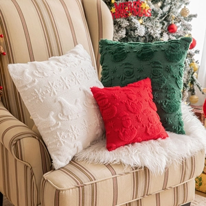 Christmas embroidered throw pillow covers with snowflake and sleigh patterns on a sofa