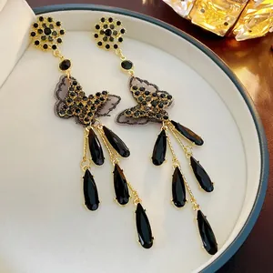 Elegant gold bow butterfly tassel earrings with black crystals and lace mesh detail