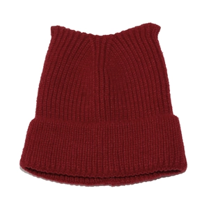 Detail of dark red knit cat ear beanie with thick rib-knit texture and folded cuff