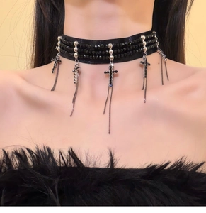 Detail of gothic black velvet choker featuring beaded strands and silver cross tassels