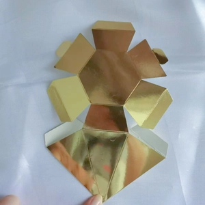 Detailed flat layout of a gold diamond-shaped paper wedding candy box before assembly