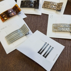 Detail of handmade tortoiseshell and marble patterned hair clips on display cards
