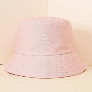 Close-up of NO BAD VIBES embroidery on light pink cotton twill bucket hat