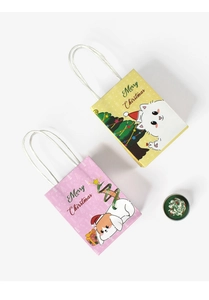 Detail view of yellow and pink Christmas paper gift bags with festive cartoon patterns