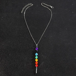 Macro shot of 7 chakra stone pendant necklace with silver chain and lobster clasp