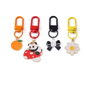Fashion metal keychains with orange, panda, mushroom, bow, and daisy flower charms