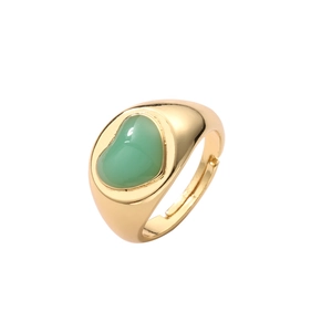 Close-up of golden adjustable open ring featuring a green heart gemstone inlay