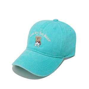 Close-up of sky blue baseball cap featuring Lucky So Bear embroidery and cotton texture