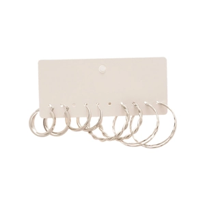 Minimalist silver hoop earring set featuring polished, thin, and twisted circle designs