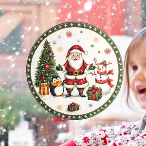 Detail of Christmas window clings featuring Santa, snowman and penguins in a snowy scene