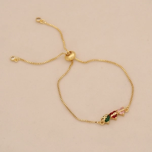 Adjustable gold box chain bracelet with green, red, and pink gemstones details