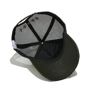 Detailed interior of mesh trucker cap showing breathable lining and vintage distressed brim