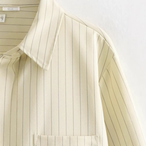 Front view of beige striped cropped shirt featuring a classic collar and chest pocket