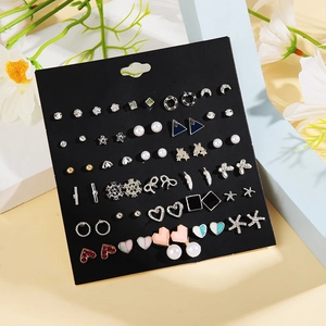 30 pairs of assorted pearl and heart stud earrings set displayed with floral decor