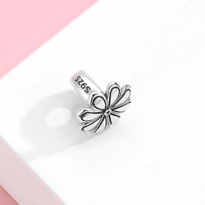 Daisy flower earring charm in S925 sterling silver on a professional display stand