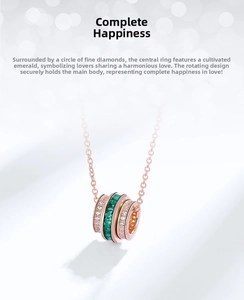 Rotating rose gold pendant featuring a lab-grown emerald and sparkling zircon accents