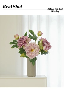 Detail of faux peony silk petals and textured ceramic vase in a soft white setting