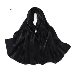 Detail view of smooth black satin fabric with elegant drape and soft silky texture