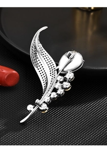 Detail showing the silver leaf brooch back pin mechanism and crystal inlay craftsmanship