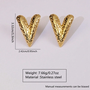 Macro shot of 18k gold plated heart earrings with hammered texture and dimensions