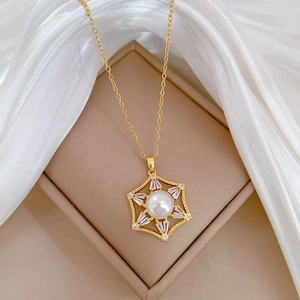 Detailed macro view of gold hexagon star necklace with pearl and sparkling zircon stones