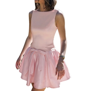 Detailed view of pink mini dress featuring a sleeveless bodice and waist bow decoration