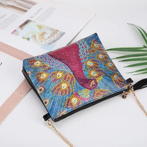 Detail of DIY diamond painting cross-body bag with peacock pattern and gold chain strap