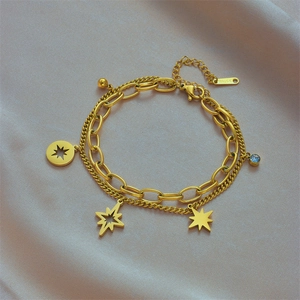Double-layered gold stainless steel bracelet featuring star charms and a blue crystal pendant