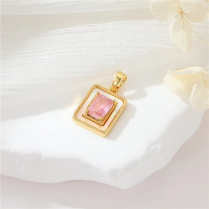 Vintage gold pendant with pink gemstone and white enamel on a soft decorative background