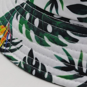 Double-sided sun hat with tropical green leaf print and reinforced brim stitching