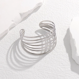 Detailed view of silver wide cuff bracelet with multi-layered hollow stainless steel lines