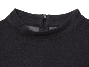 Detail shot of black knitted dress featuring high collar and metal back zipper closure