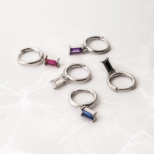Detailed macro shot of S925 silver hoop earrings with multicolored rectangle gemstones