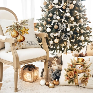 Close-up of luxury Christmas pillow covers with gold snowman and Merry Christmas text